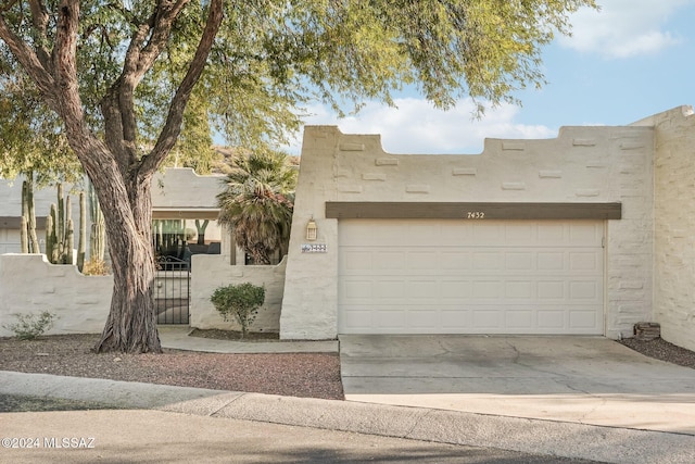 southwest-style home featuring a garage