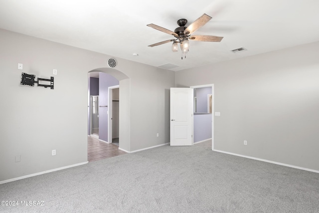 empty room with ceiling fan and light colored carpet