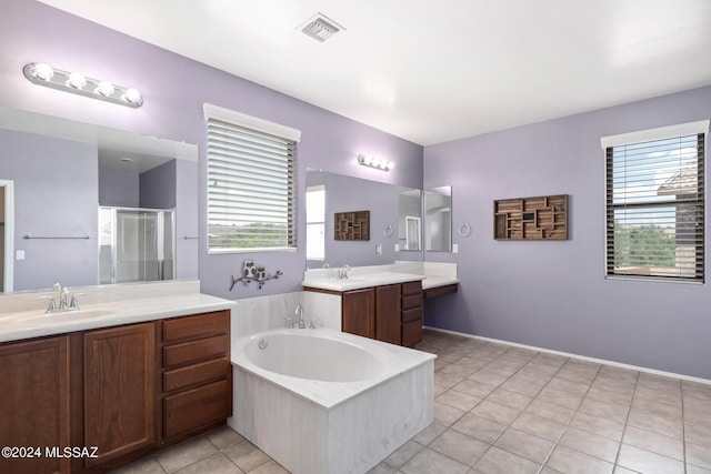 bathroom featuring a wealth of natural light, tile patterned flooring, separate shower and tub, and vanity