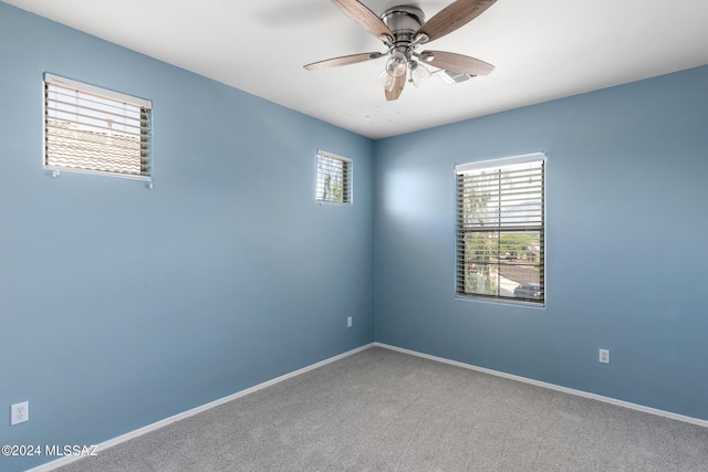 carpeted empty room featuring ceiling fan