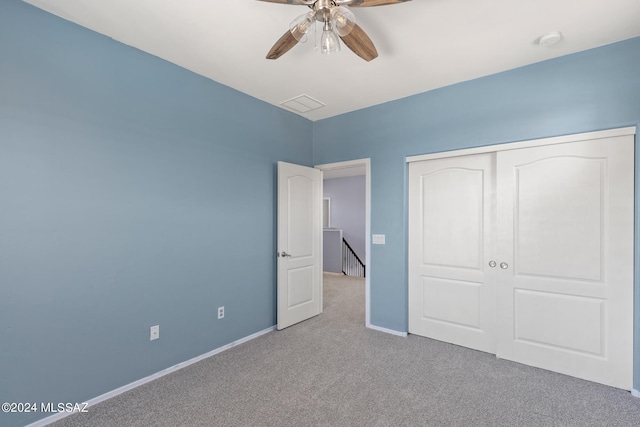 unfurnished bedroom with ceiling fan, a closet, and light colored carpet