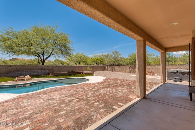 view of pool featuring a hot tub and a patio area