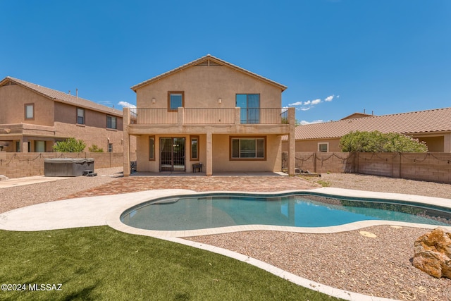 view of swimming pool with a hot tub and a patio area