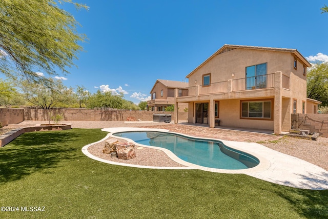 view of pool with a patio area and a yard