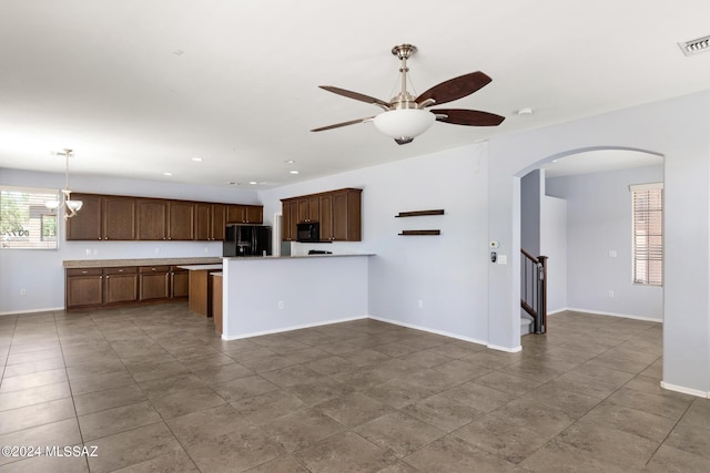 kitchen featuring ceiling fan, pendant lighting, black appliances, and kitchen peninsula