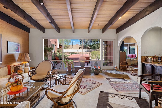 living room with french doors, beamed ceiling, and wood ceiling