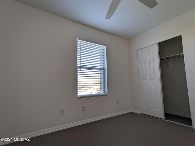 unfurnished bedroom with ceiling fan and a closet