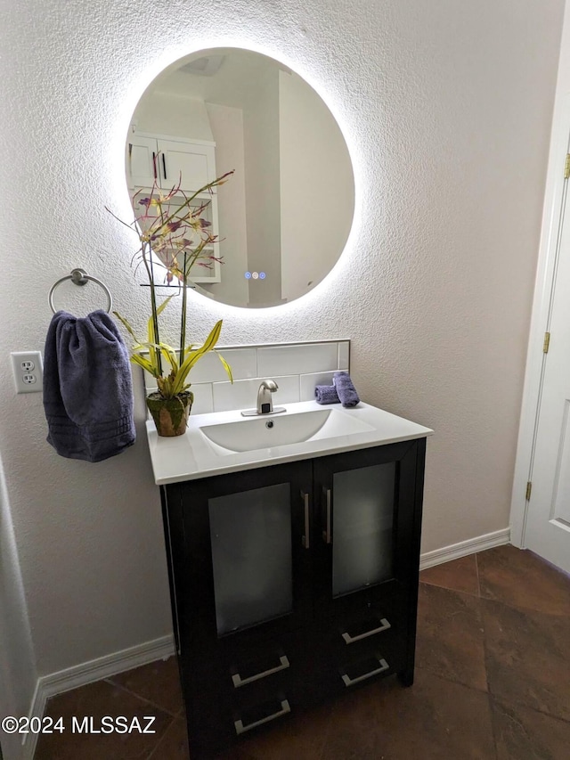 bathroom with tile patterned floors, tasteful backsplash, and vanity