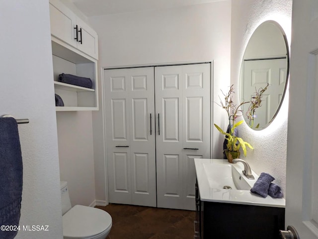 bathroom with vanity and toilet