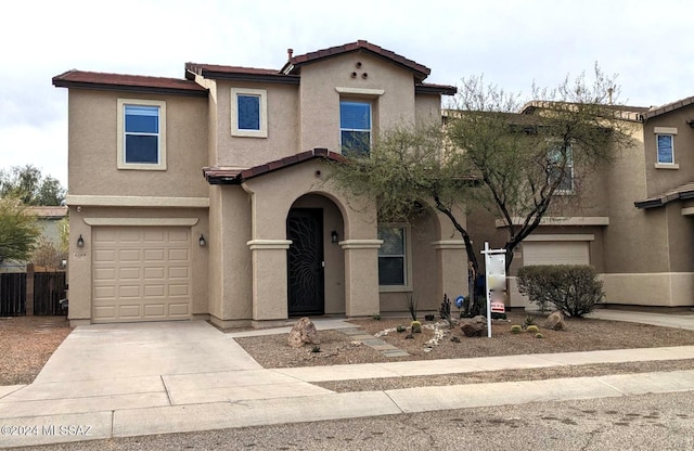 mediterranean / spanish house featuring a garage