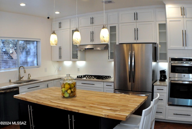 kitchen with white cabinets, a kitchen island, and appliances with stainless steel finishes