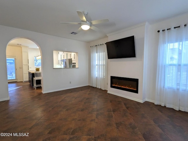 unfurnished living room with ceiling fan