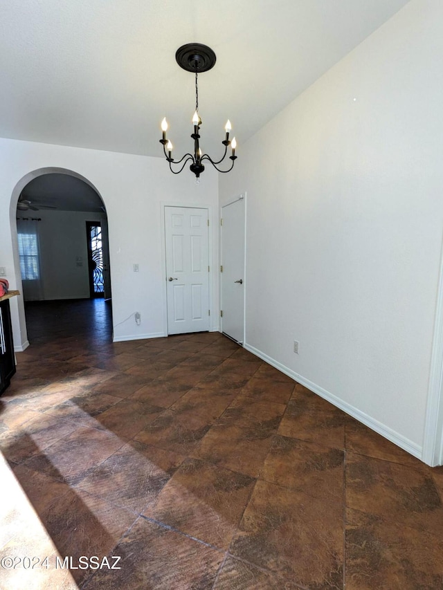 unfurnished dining area with a notable chandelier