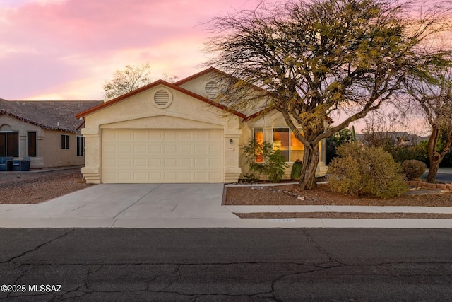 view of front of house with a garage and central air condition unit