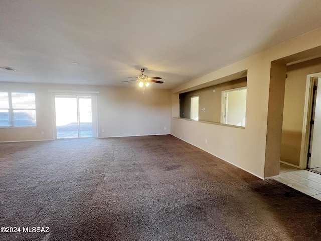 spare room featuring light colored carpet and ceiling fan