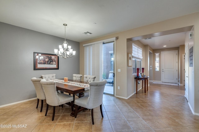 tiled dining area with a chandelier