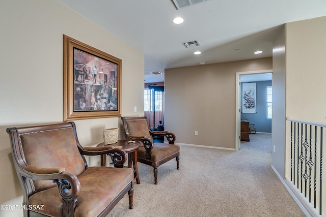 sitting room featuring light colored carpet