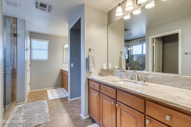 bathroom with walk in shower, vanity, and a wealth of natural light