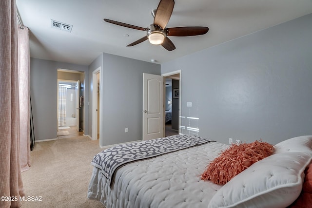 carpeted bedroom featuring ensuite bath and ceiling fan