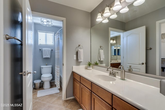 bathroom with a shower with shower curtain, tile patterned floors, vanity, and toilet