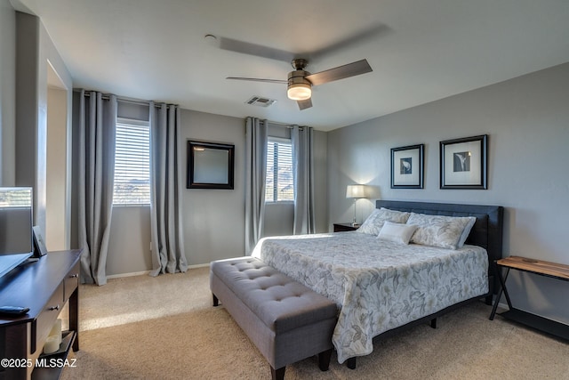 bedroom featuring multiple windows, light colored carpet, and ceiling fan