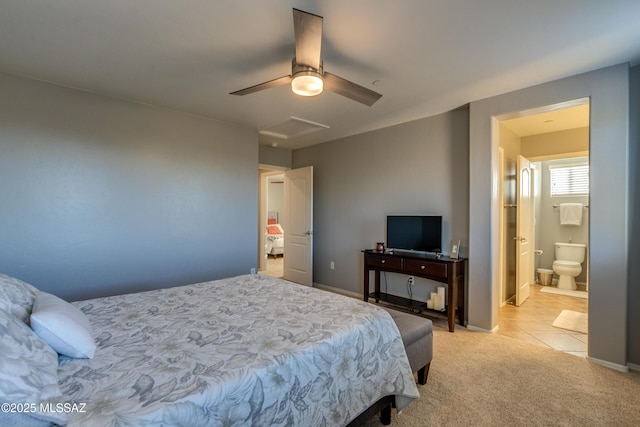 bedroom with connected bathroom, light colored carpet, and ceiling fan