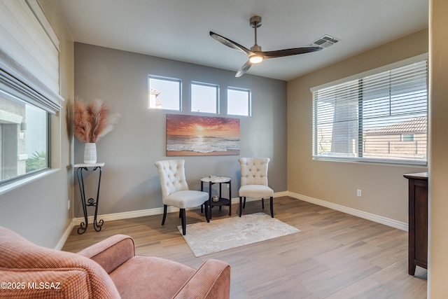 sitting room with ceiling fan and light hardwood / wood-style floors