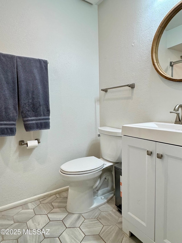 bathroom featuring tile patterned floors, vanity, and toilet