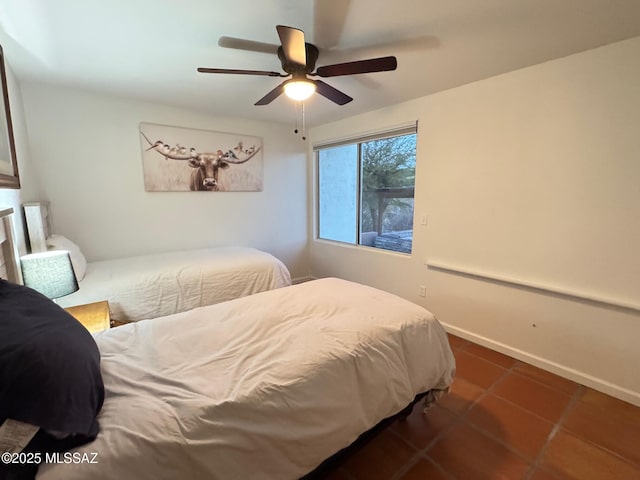 tiled bedroom with ceiling fan