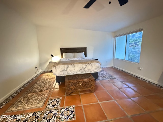 tiled bedroom featuring ceiling fan