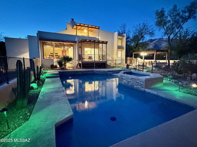 view of pool with an in ground hot tub