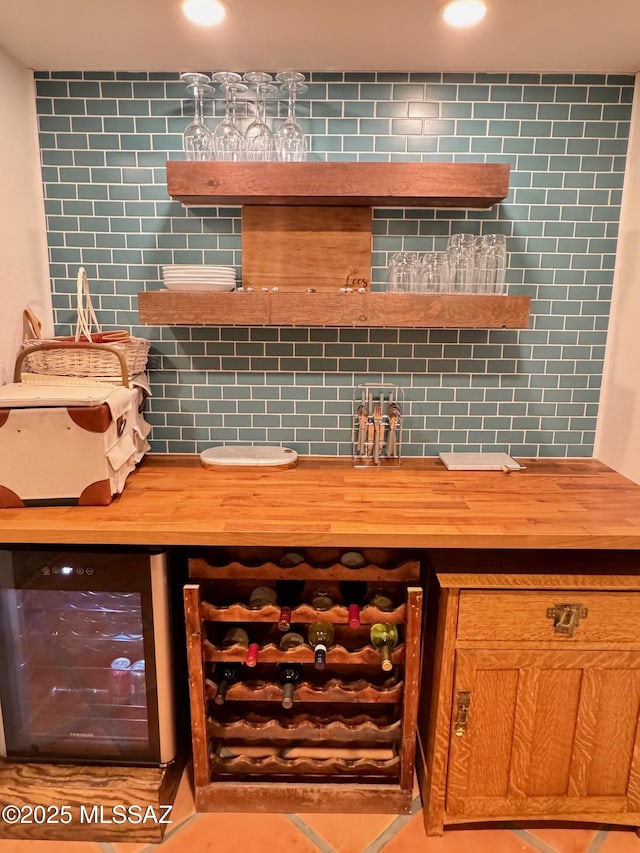 bar featuring wood counters, tile patterned floors, and wine cooler