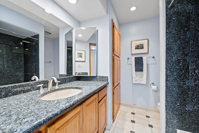 bathroom featuring vanity, tile patterned flooring, a shower, and toilet