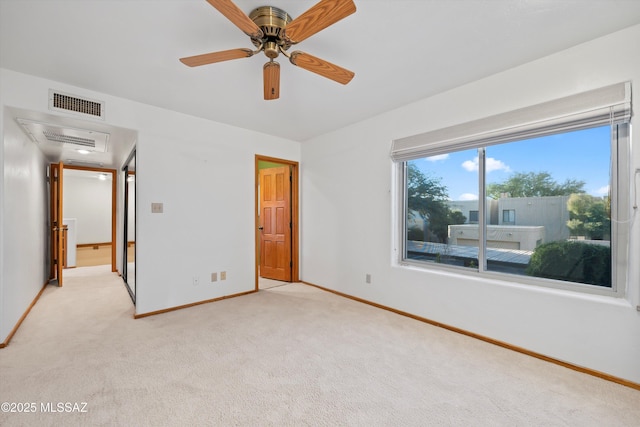 unfurnished bedroom featuring ceiling fan and light colored carpet