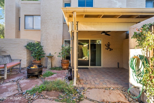 view of patio / terrace featuring ceiling fan and an outdoor fire pit