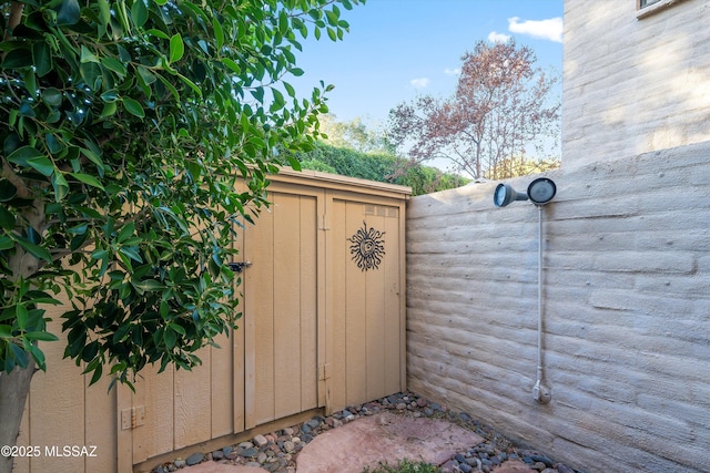 view of gate with a storage shed