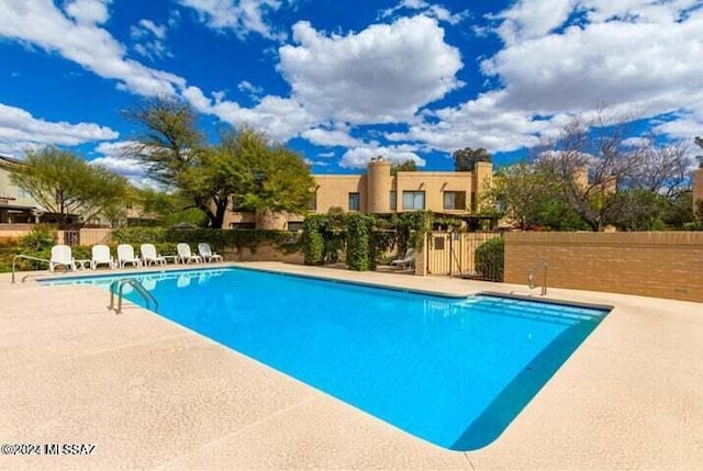 view of swimming pool with a patio area