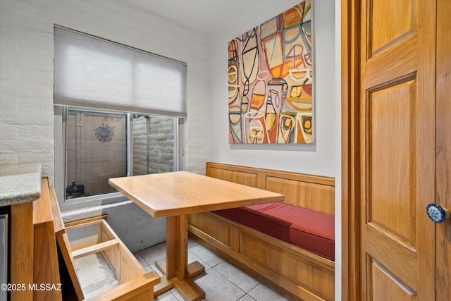 dining area featuring light tile patterned floors and breakfast area