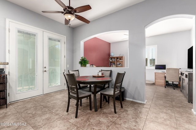 dining area featuring ceiling fan, light tile patterned floors, and french doors