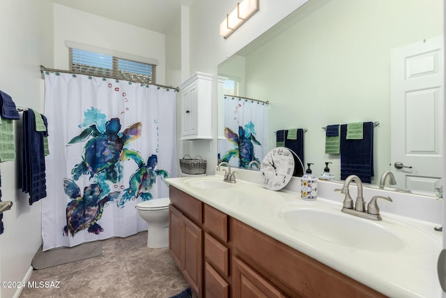 bathroom featuring vanity, toilet, and curtained shower