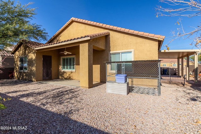 rear view of property with a patio and ceiling fan