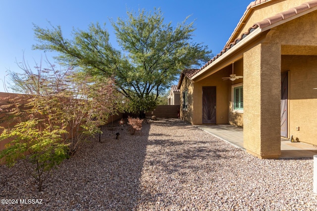 view of yard with ceiling fan and a patio area