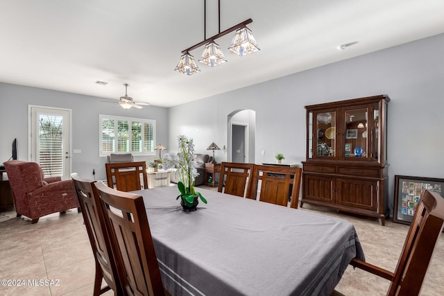 dining space with ceiling fan and light tile patterned flooring