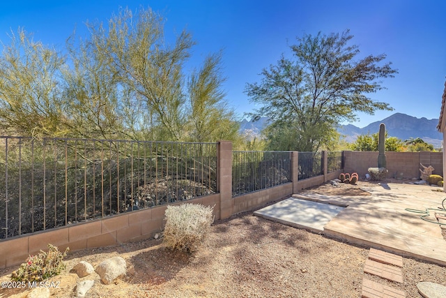 view of yard featuring a mountain view and a patio area