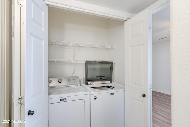 washroom featuring hardwood / wood-style floors and independent washer and dryer