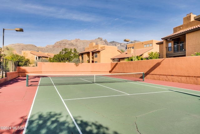 view of tennis court with a mountain view and basketball court