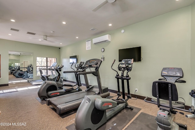 exercise room featuring a wall unit AC, ceiling fan, and light colored carpet