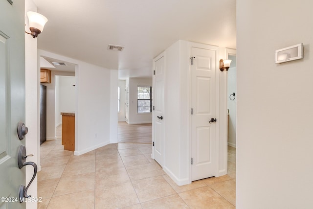 hall with light tile patterned floors