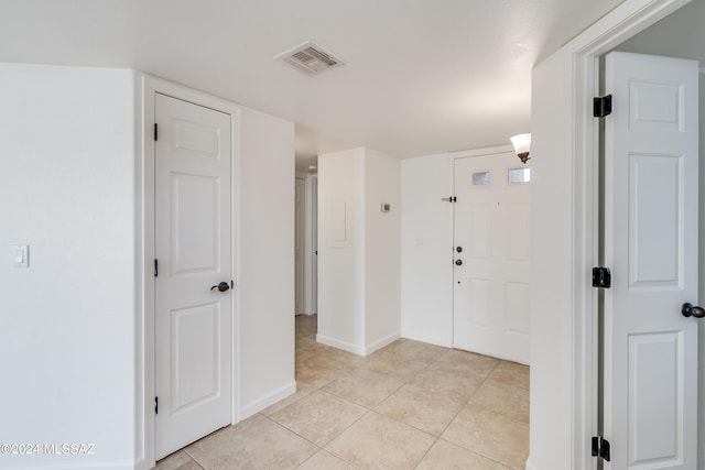 entryway with light tile patterned flooring