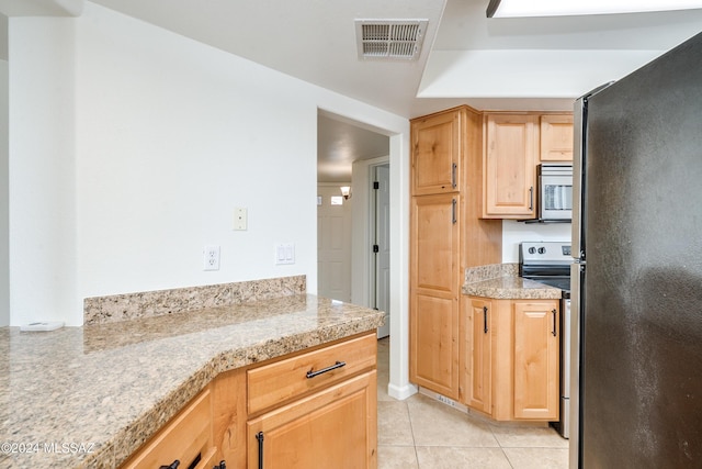 kitchen with light tile patterned flooring and stainless steel appliances